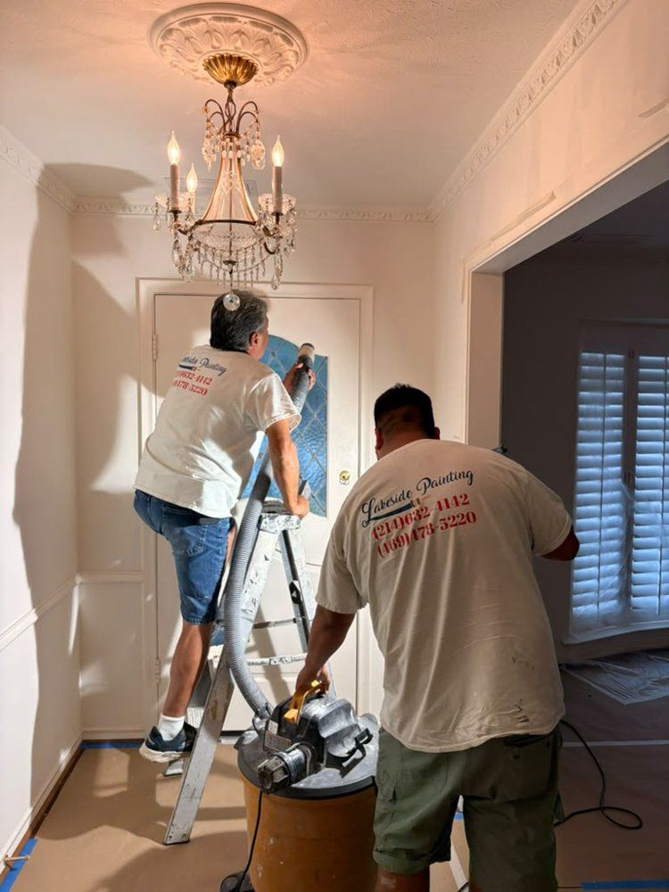 Lakeside team sanding and vacuuming an entryway ceiling
