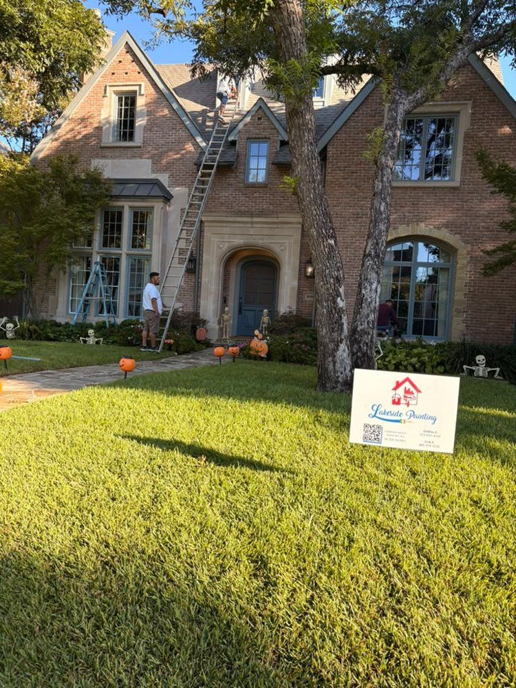 Lakeside crew working on a brick home exterior with a Lakeside Painting yard sign